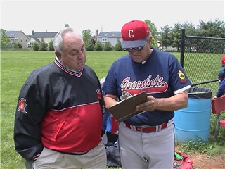 Manager Dinks Lloyd reviews the schedule with Coach Truman