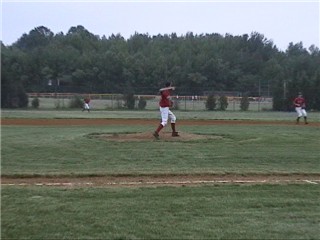 Jon Lappin on the mound fields a ball and throws to his favorite base for a double play in the 7th