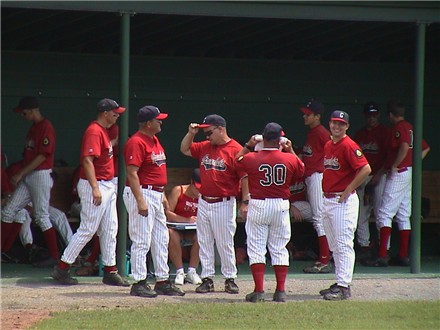 Coaches confer before the action